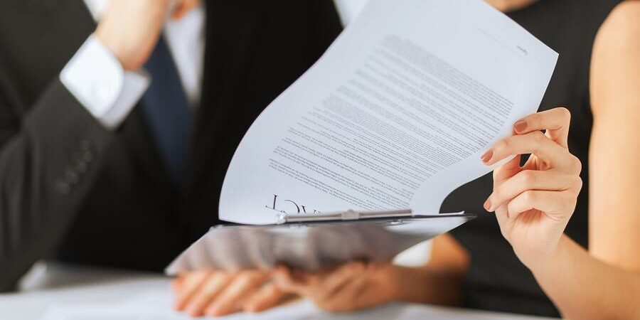 business, office, law and legal concept - picture of man and woman hand signing contract paper